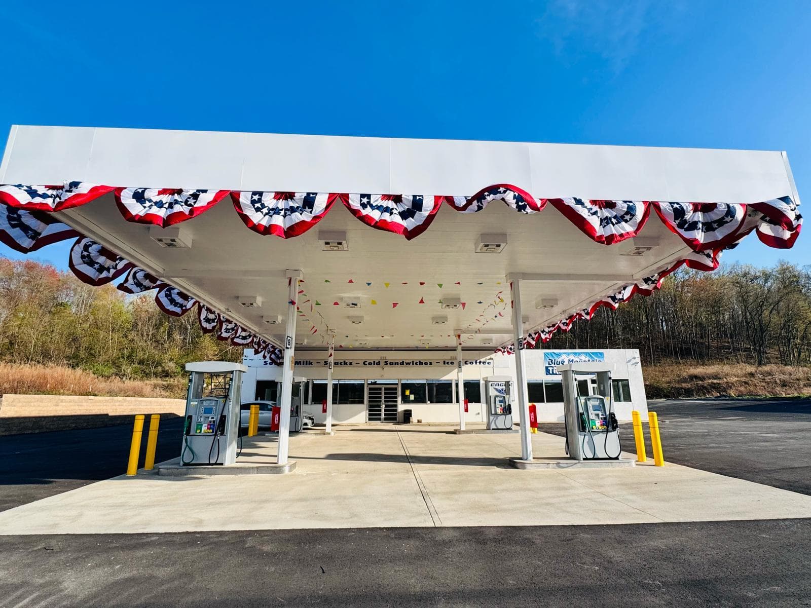 Front view of the fuel canopy with red, white, and blue bunting