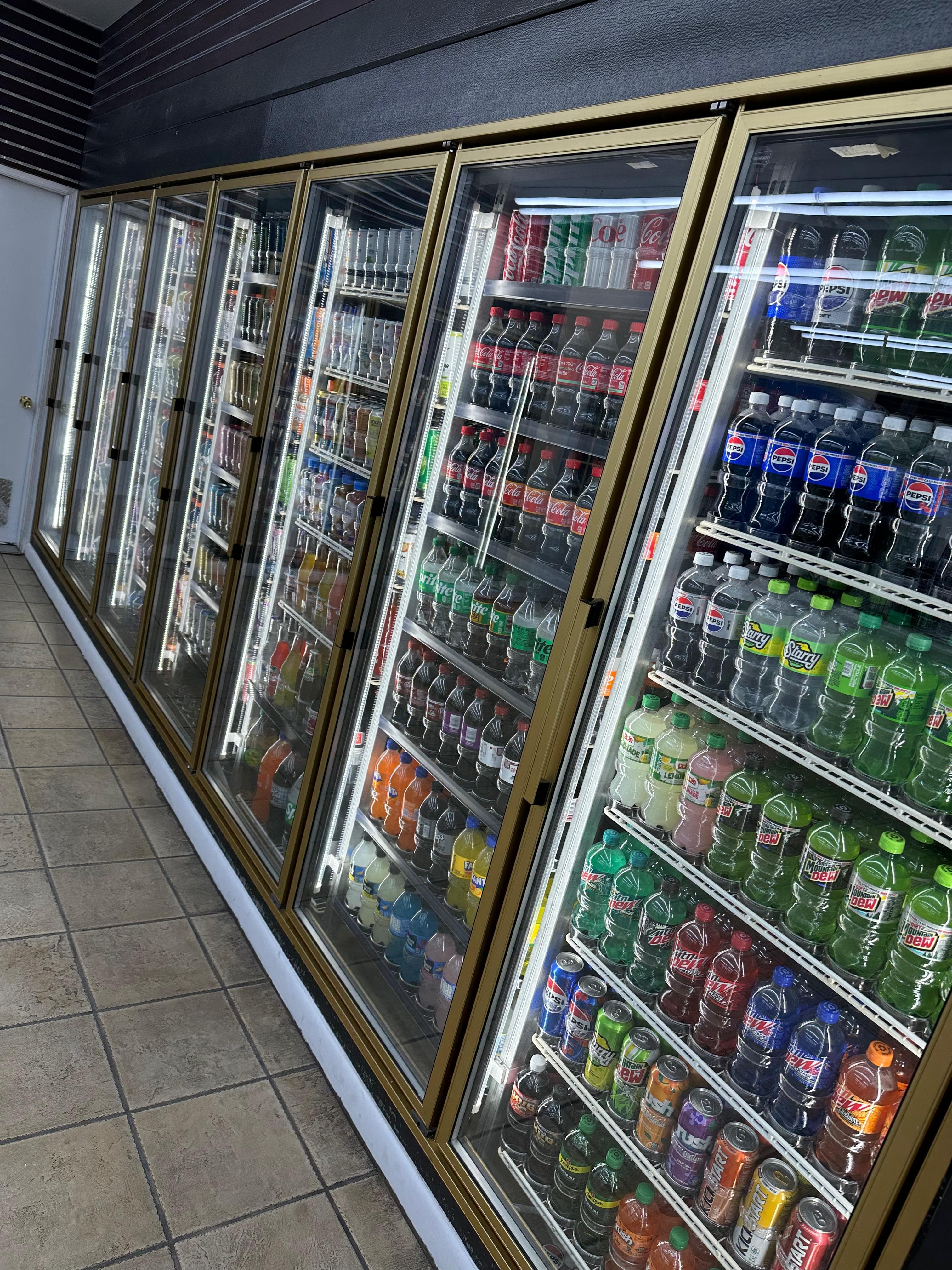 Fully stocked beverage coolers inside Eagle Mart