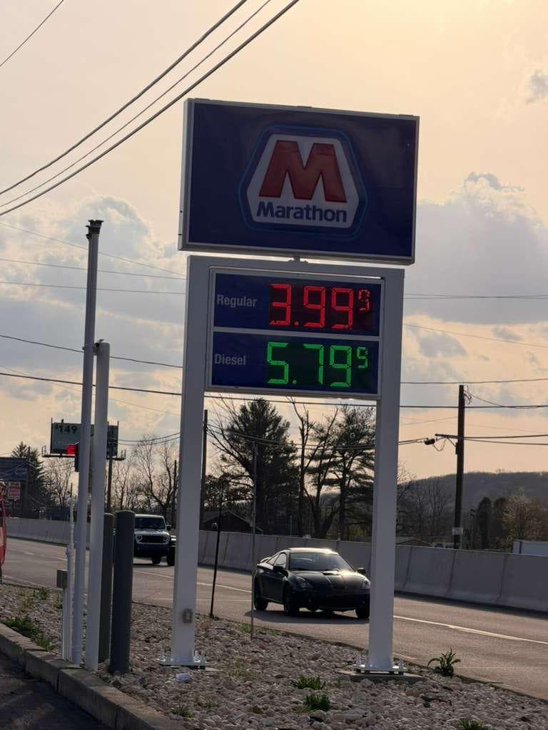 Marathon roadside price sign visible from PA-61 at sunset